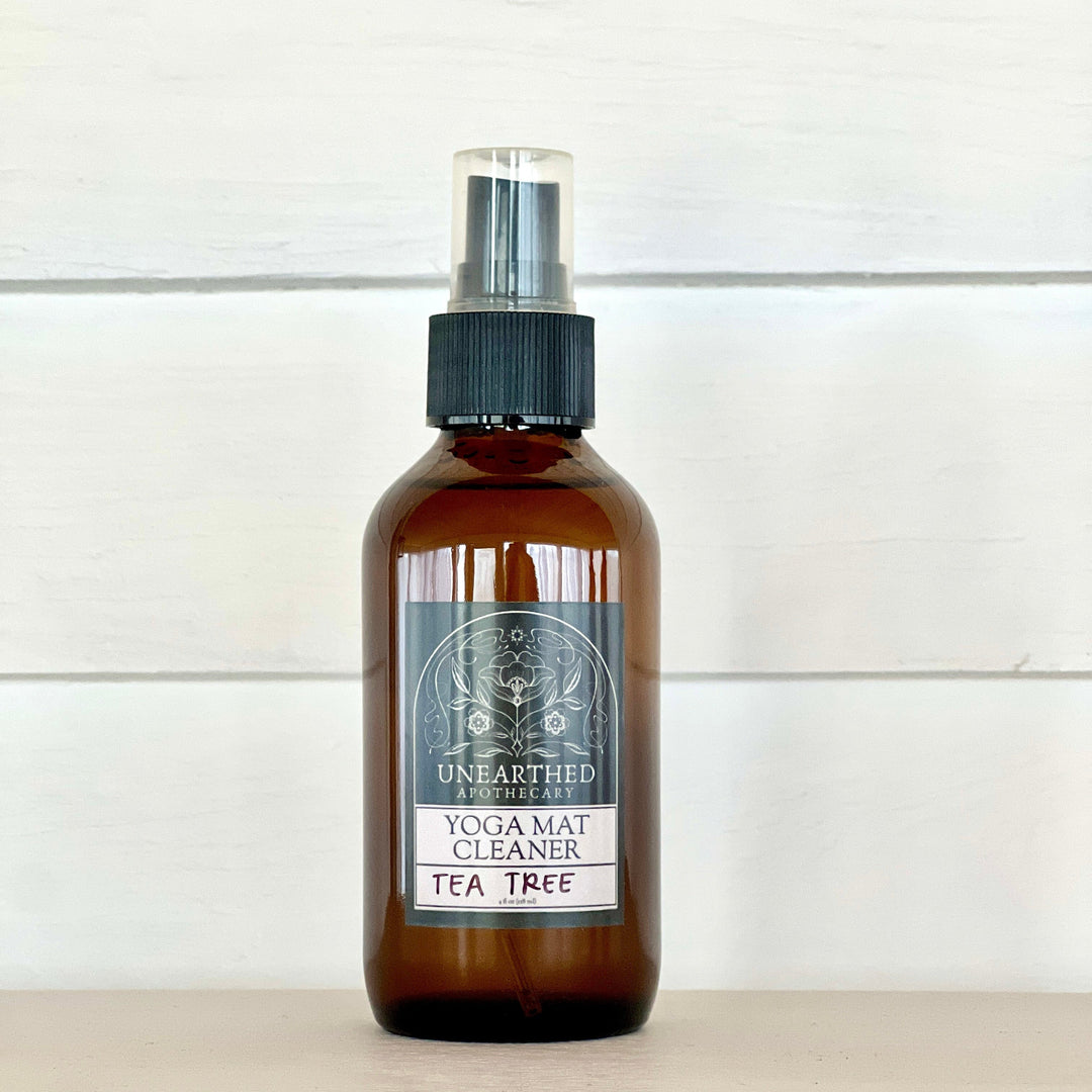 Yoga mat cleaning spray bottle with tea tree label, amber glass and black mist sprayer