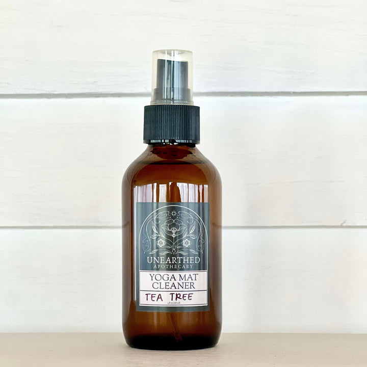 Yoga mat cleaning spray bottle with tea tree label, amber glass and black mist sprayer