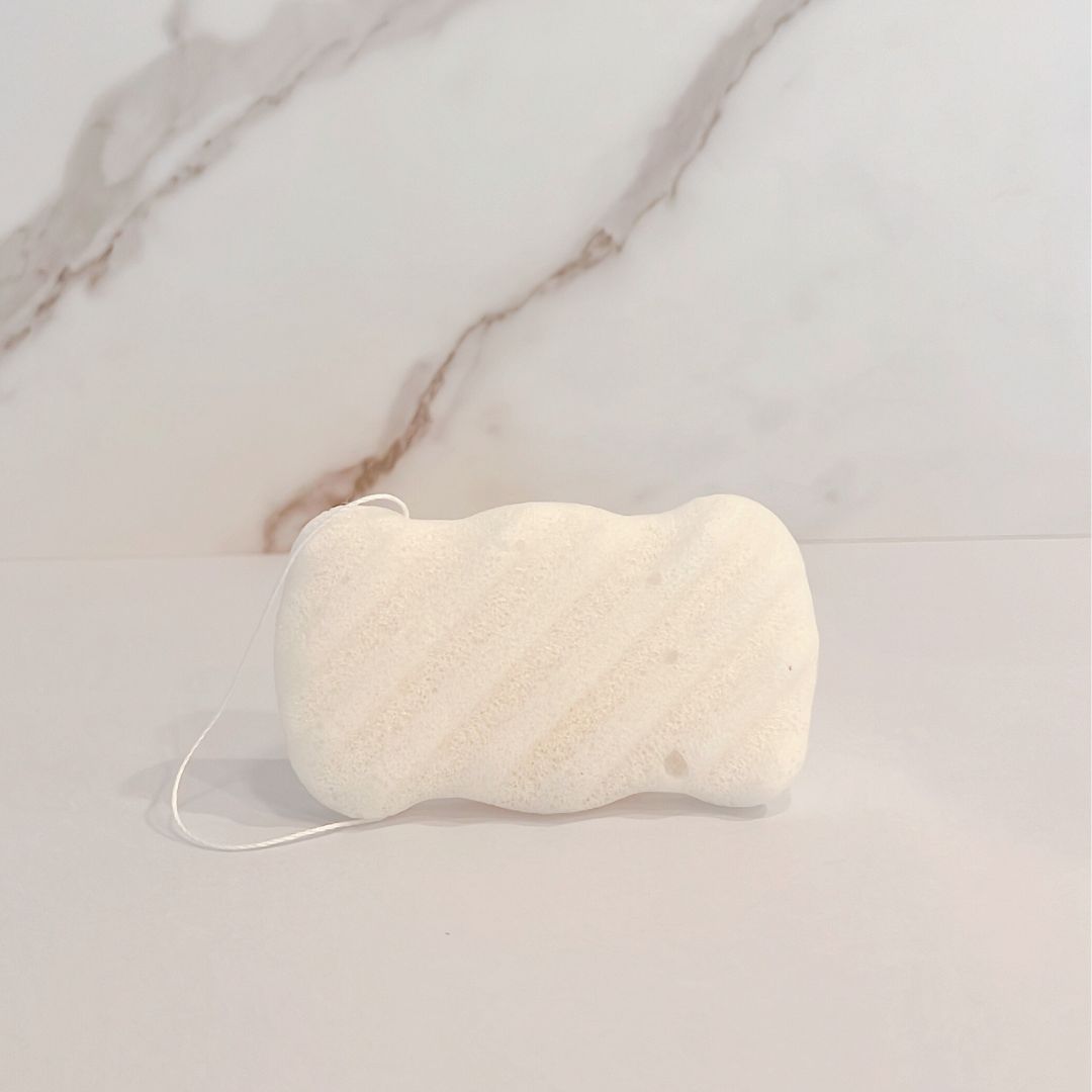 Off-white konjac root body sponge with looped hanging cord