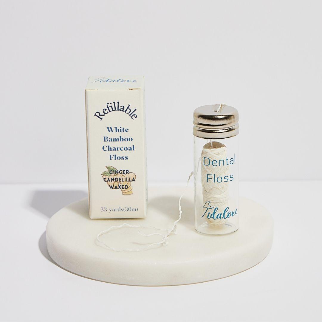 Refillable dental floss twin pack with two small floss containers and white floss thread