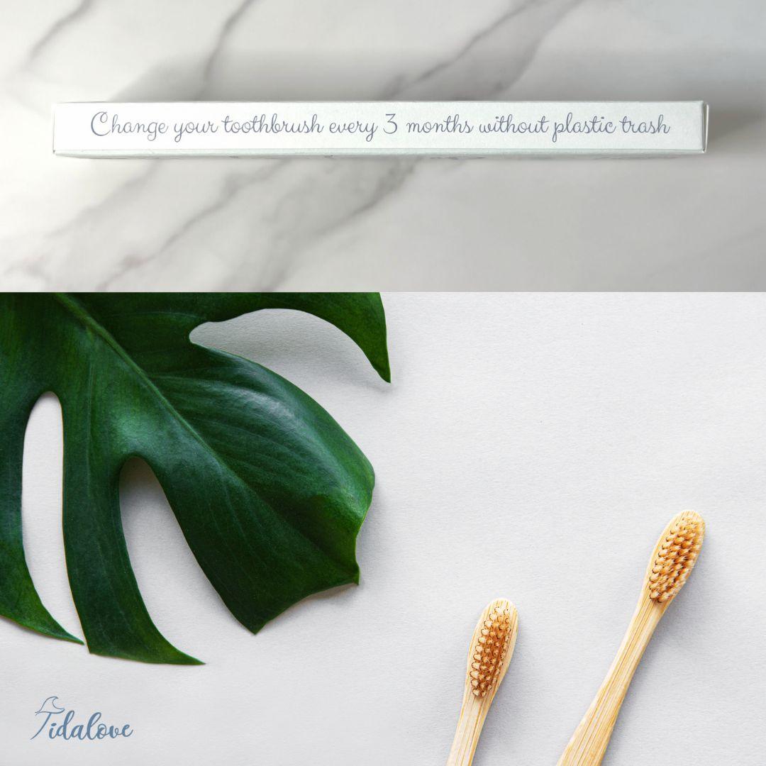 Bamboo toothbrush twin pack with two wooden handles and orange bristle heads