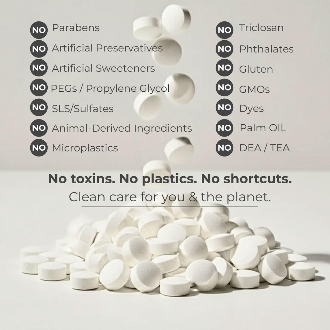 White toothpaste tablets scattered with icons listing no-ingredient claims
