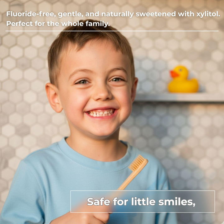 Child holding a toothbrush with fluoride-free toothpaste tablets shown