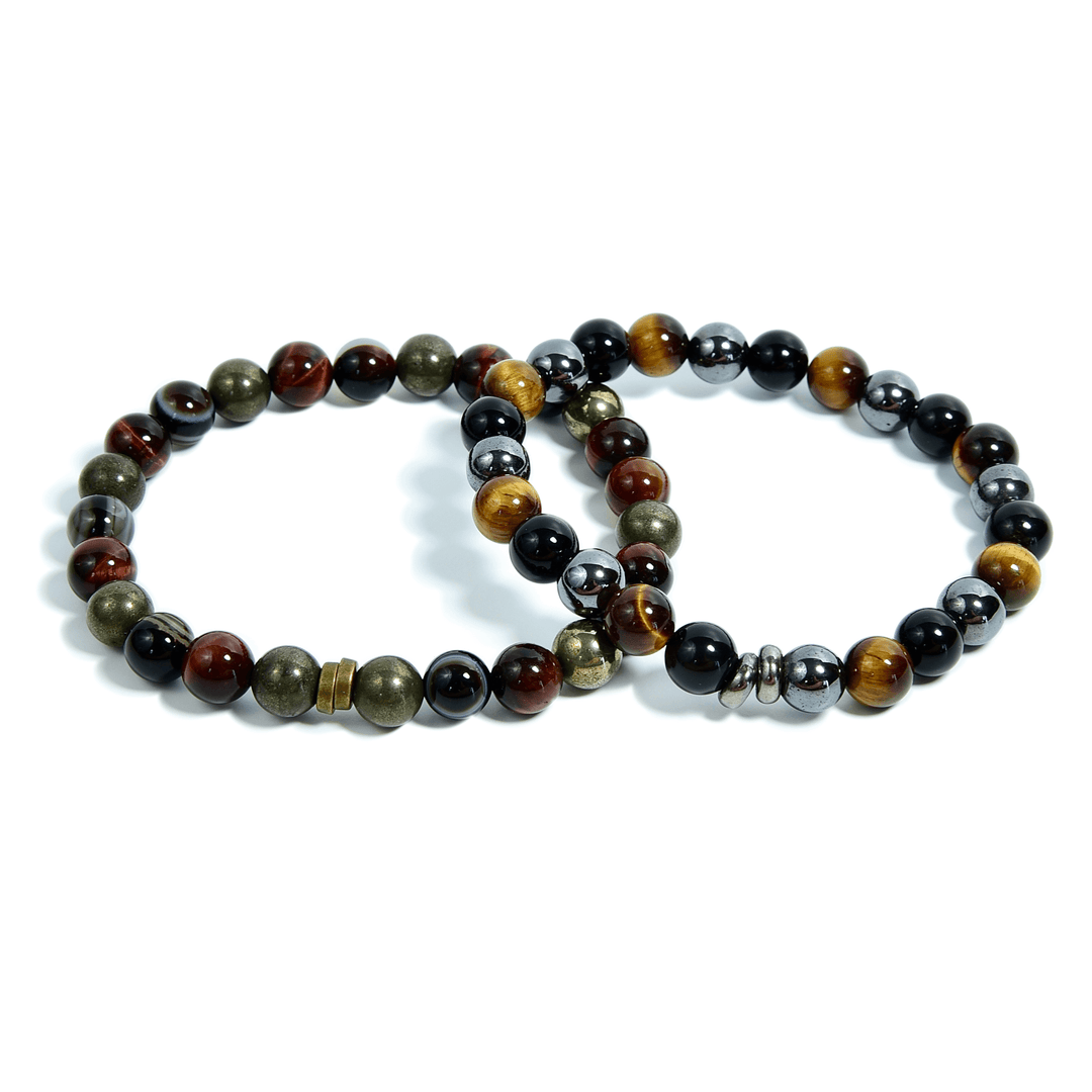 Set of tiger eye bead bracelets on white background, black and brown stones with gold tones.