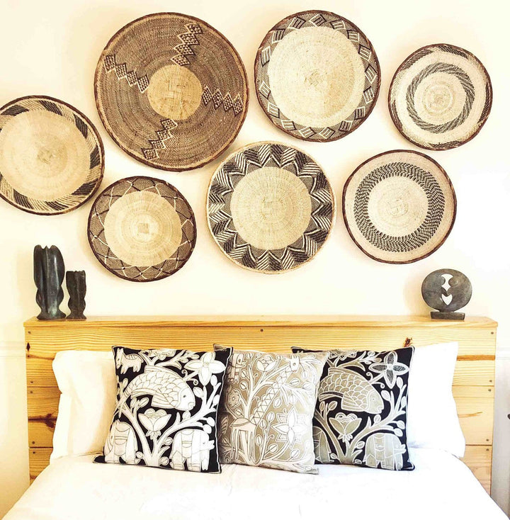 Small woven baskets set with circular geometric patterns in cream and dark brown
