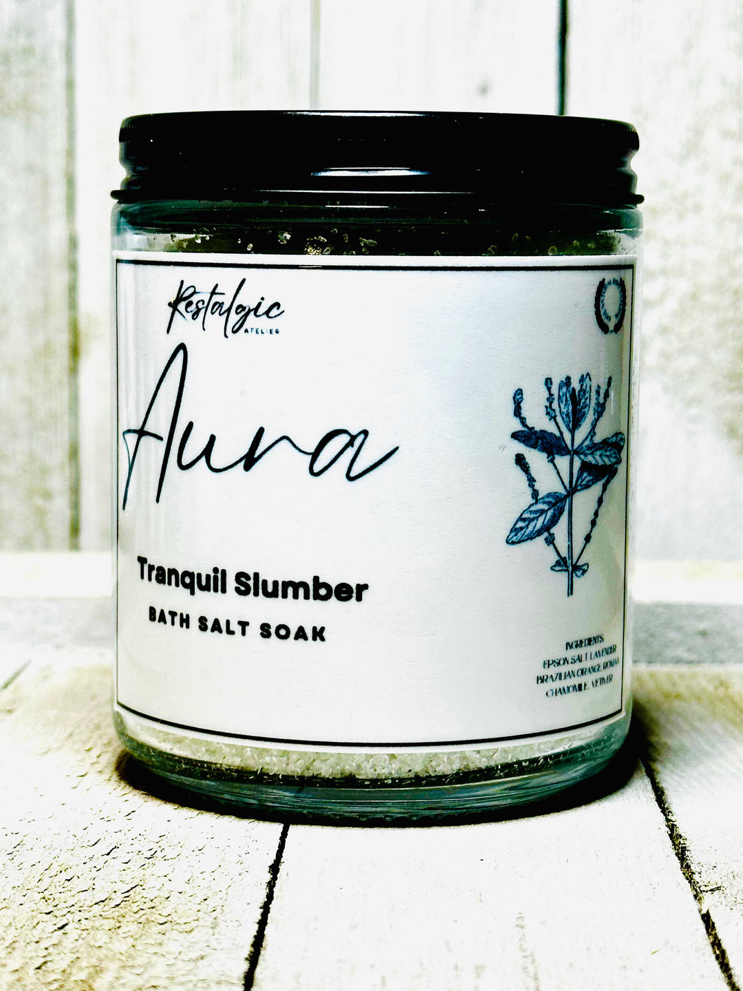 Tranquil Slumber bath salt soak jar with blue flower label and black lid