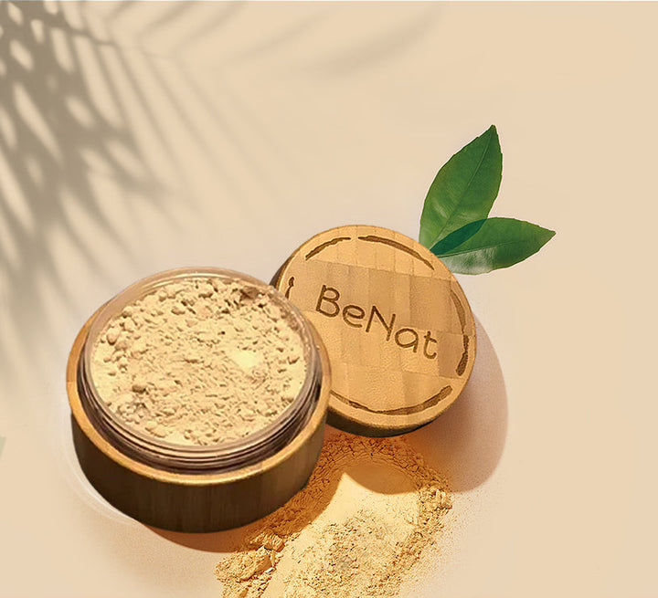 Translucent loose setting powder in open bamboo-style case, showing beige powder