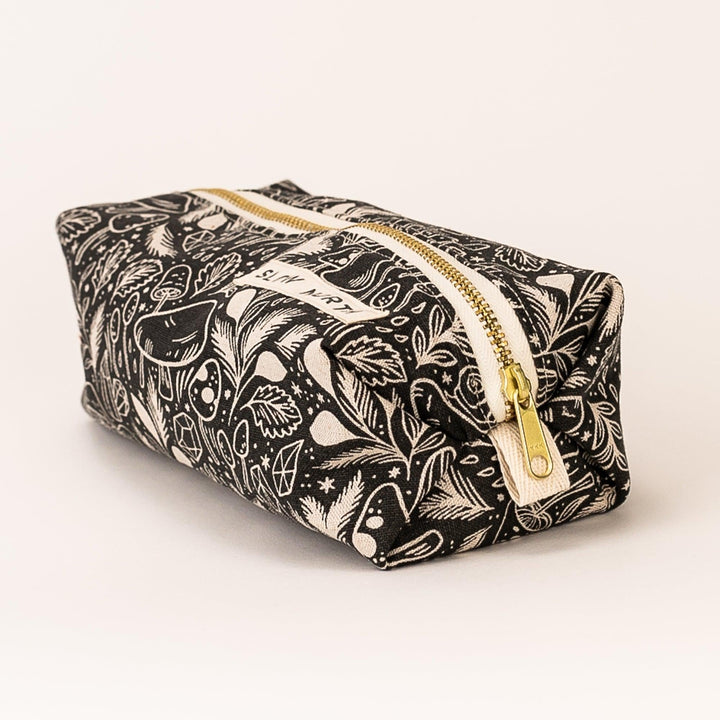 Black printed pouch with gold zipper and side view, fabric handle pull