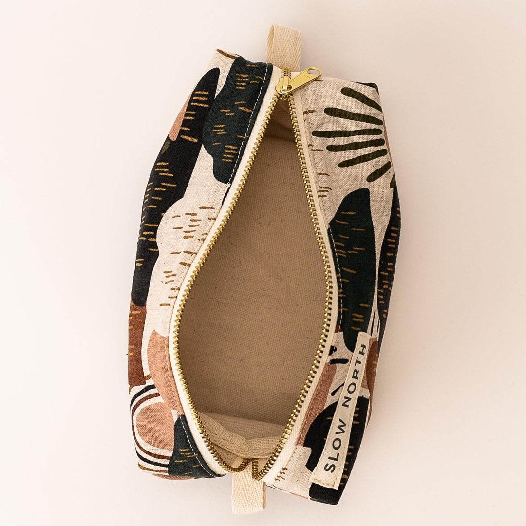 Open zipper pouch with desert-print fabric; tan interior and gold zipper pull