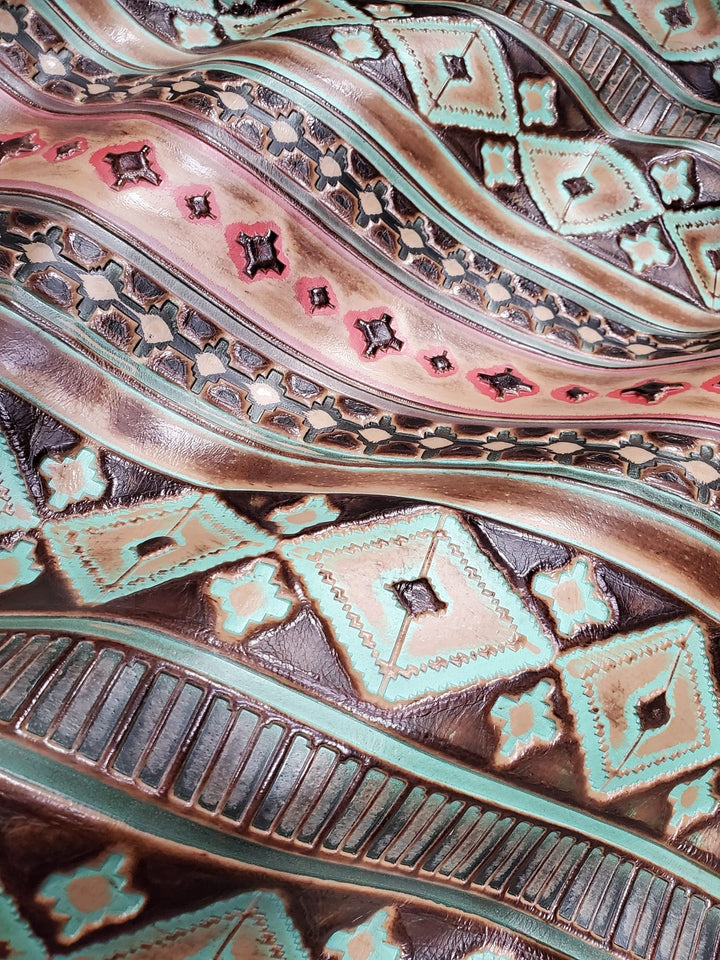 Turquoise leather hat band close-up with embossed geometric motifs and decorative shapes