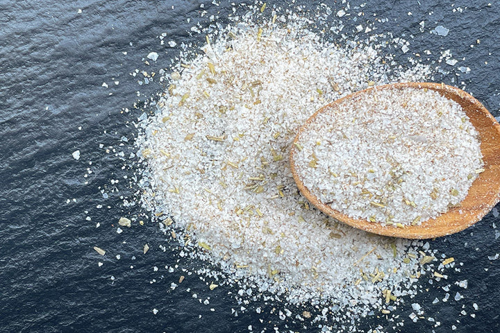 Rosemary salt with flakes in a wooden spoon