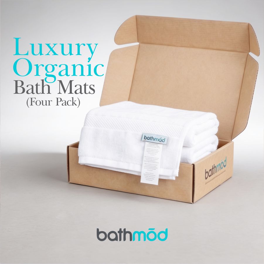 White bath mats in open brown box, four-pack presentation