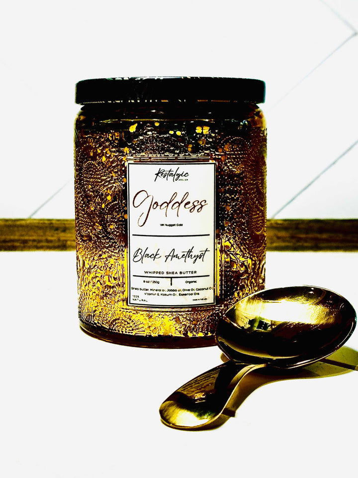 Amber-gold body butter jar with black lid and gold spoon, label reads “Black Amethyst”