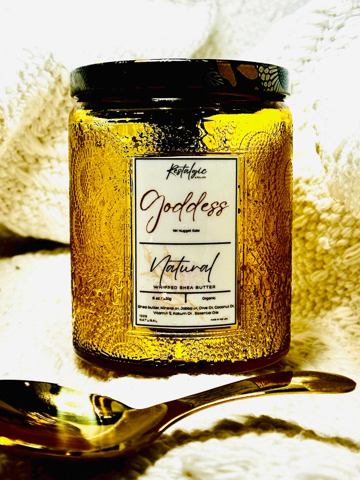Amber body butter jar with black lid, label reads “Natural” and whipped shea butter
