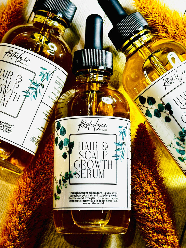 Hair &amp; scalp growth serum bottles with amber liquid, black caps, floral label