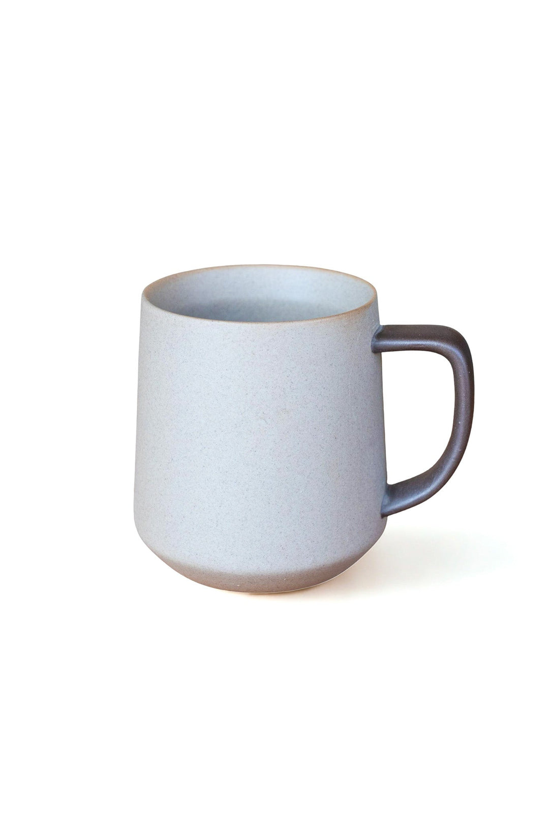 Two-tone ceramic mug with dark handle and light speckled body, rounded shape