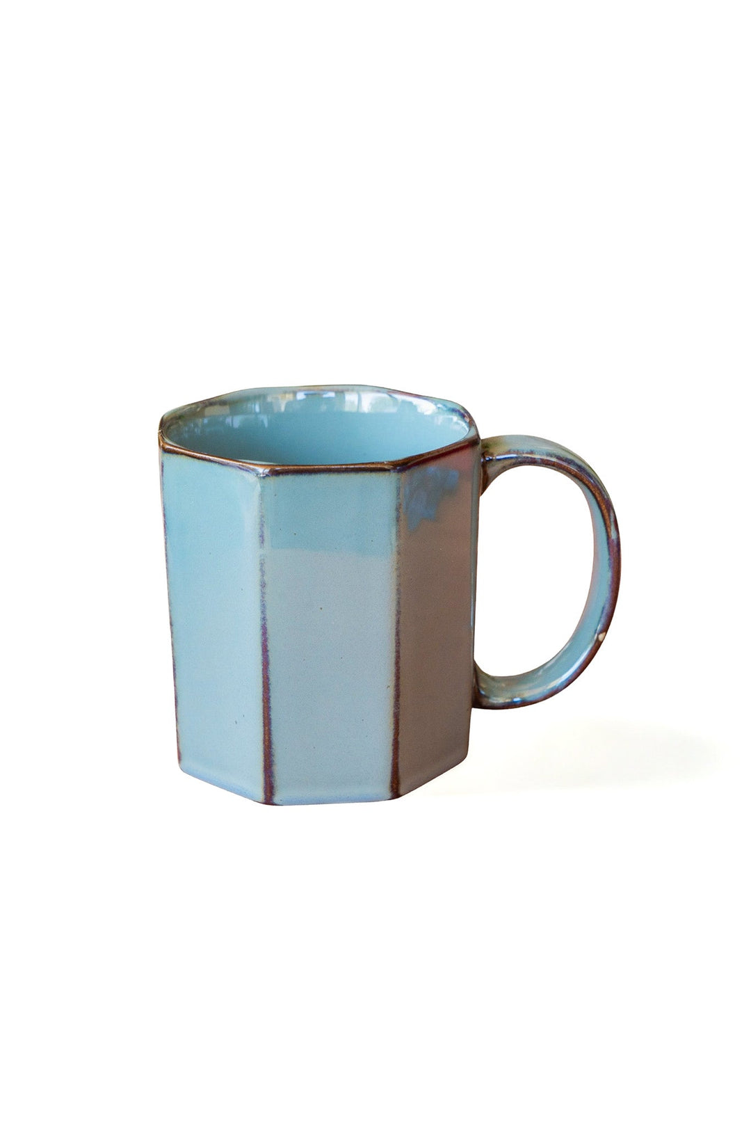 Light blue octagonal ceramic mug with handle, glossy glaze and dark rim