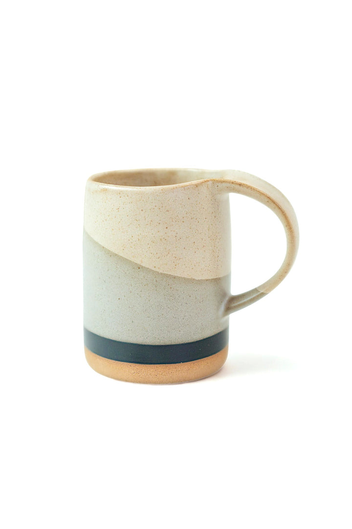 Speckled ceramic mug with curved handle and dark band detail