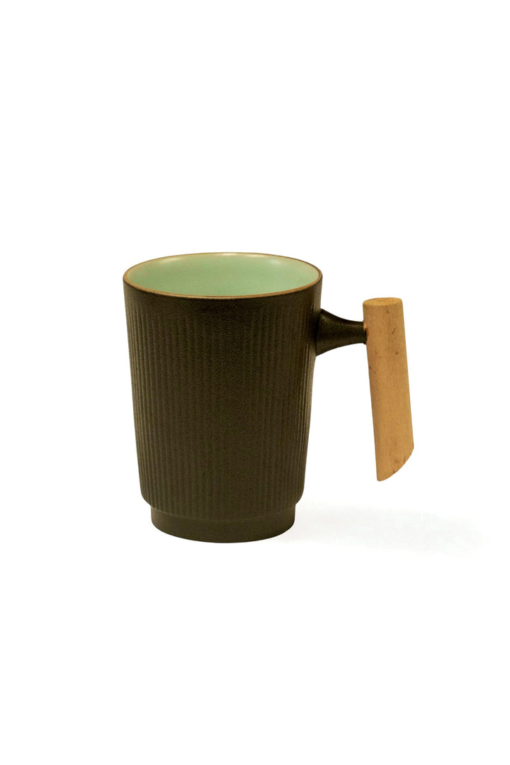 Textured dark ceramic mug with mint-green interior and light wood side handle