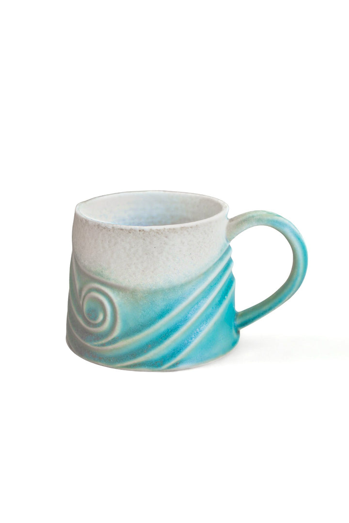 Ceramic wave mug with teal blue swirl accent and curved handle