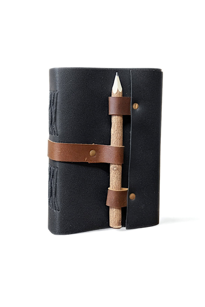 Black leather journal with attached wooden pencil in a wrap strap holder