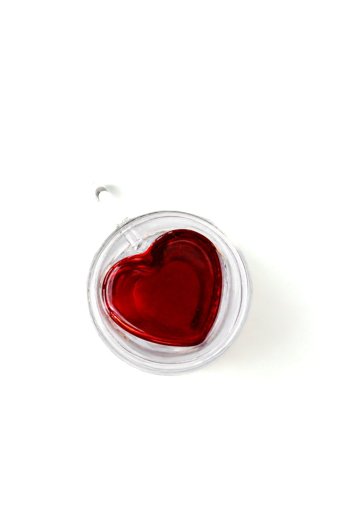 Clear double-walled glass mug with inset heart-shaped red tea