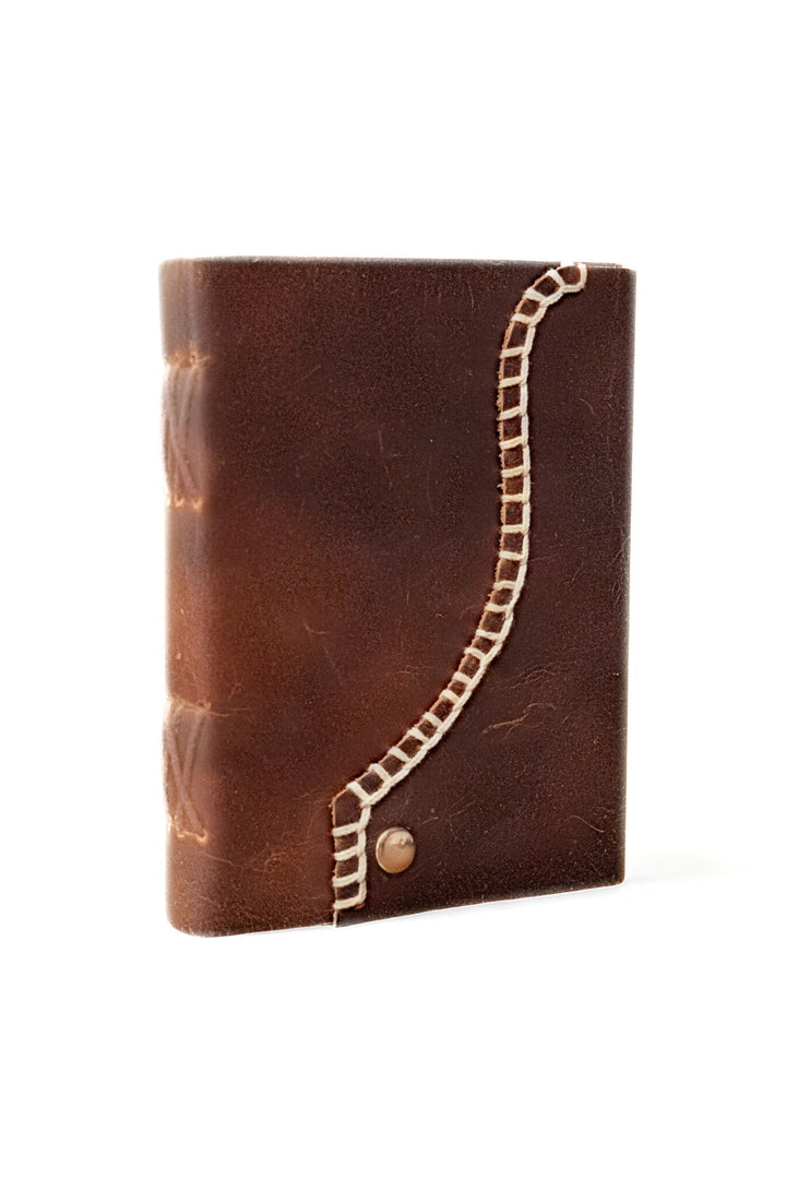 Distressed brown leather journal with white blanket edge stitching and brass button