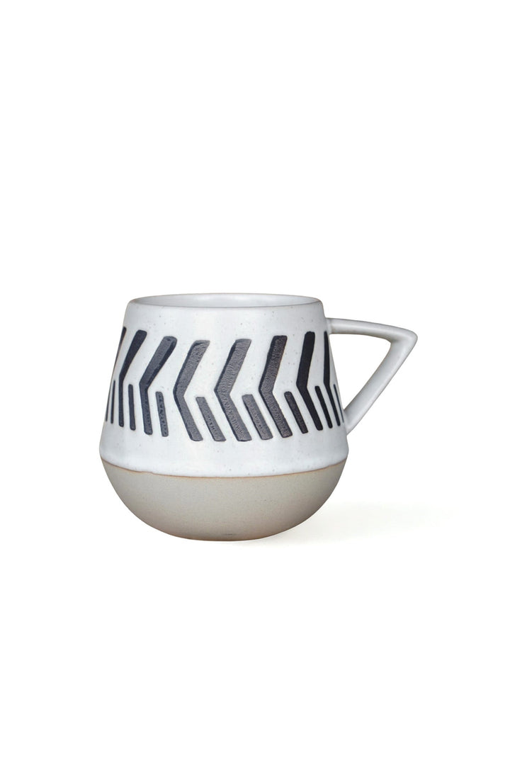 Two-toned geometric abstract ceramic mug with black pattern, white body and handle