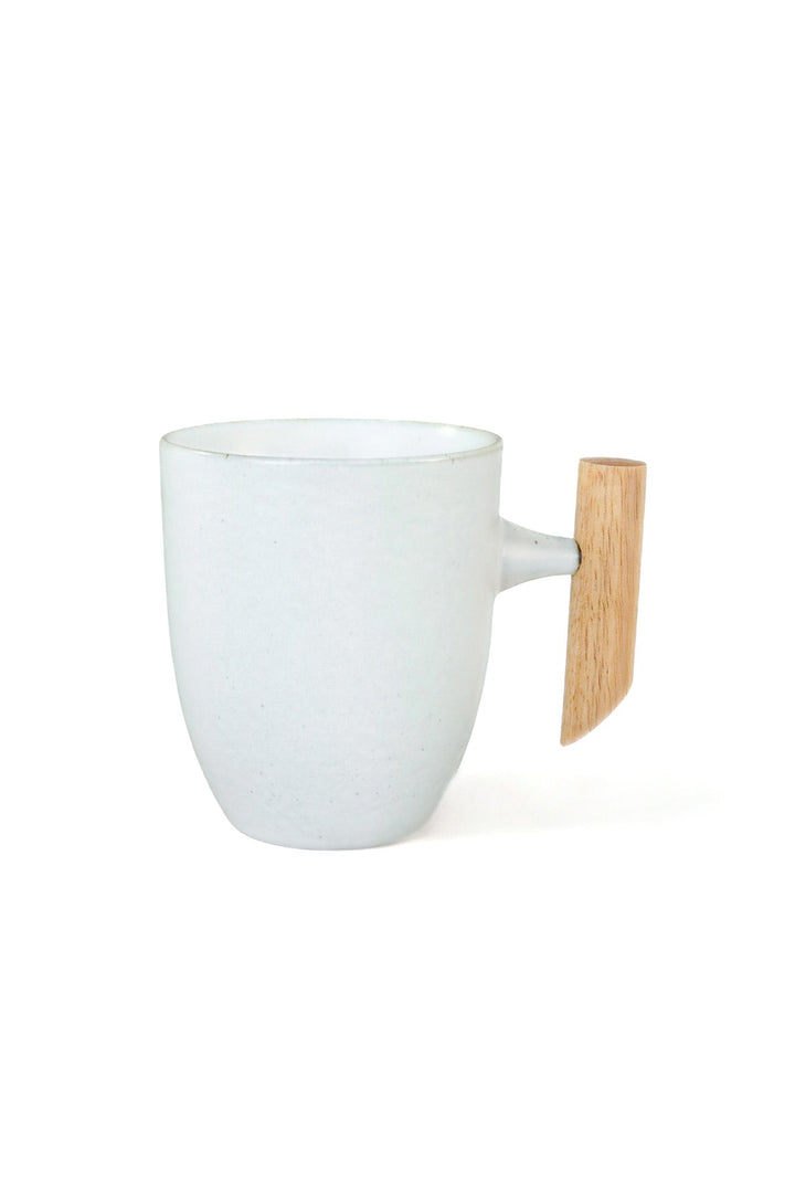 White minimalist ceramic mug with curved wooden handle and short side spout