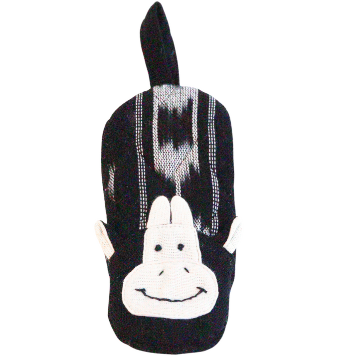Black cow skillet handle holder shaped like a cow head with plaid stripes and face