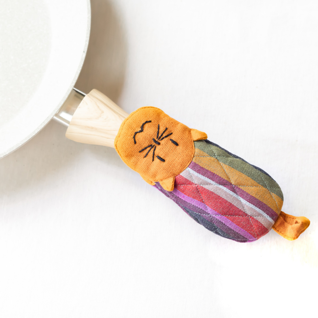 Cat skillet handle holder, orange-striped fabric with colorful stripes and black cat face.