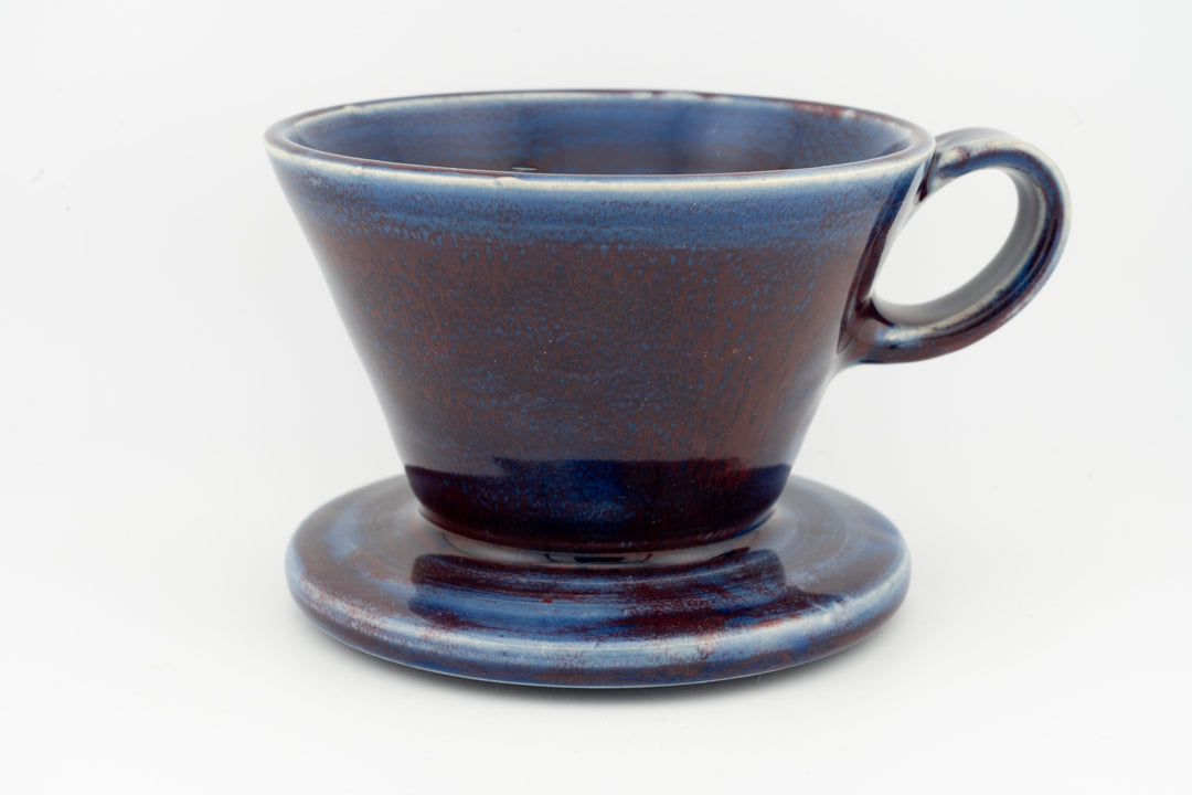 Ceramic coffee pour-over dripper with base, deep navy blue speckled glaze and handle