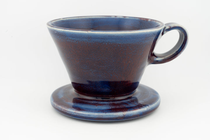Ceramic coffee pour-over dripper with base, deep navy blue speckled glaze and handle