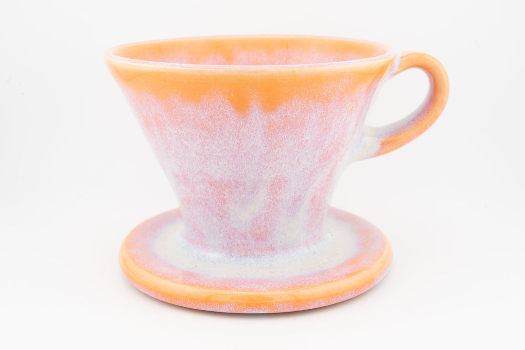 Ceramic coffee pour-over dripper with base, peach-pink speckled glaze and handle