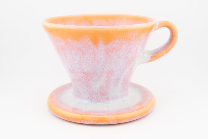 Ceramic coffee pour-over dripper with base, peach-pink speckled glaze and handle