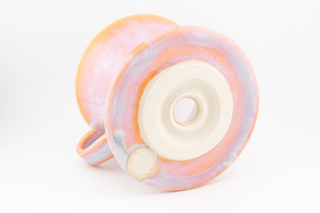 Ceramic coffee pour-over dripper base, orange-pink speckled glaze with centered outlet