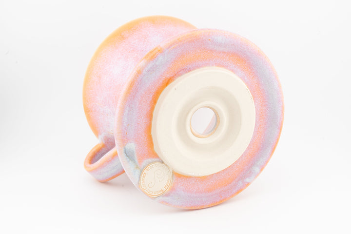 Ceramic coffee pour-over dripper base, orange-pink speckled glaze with centered outlet
