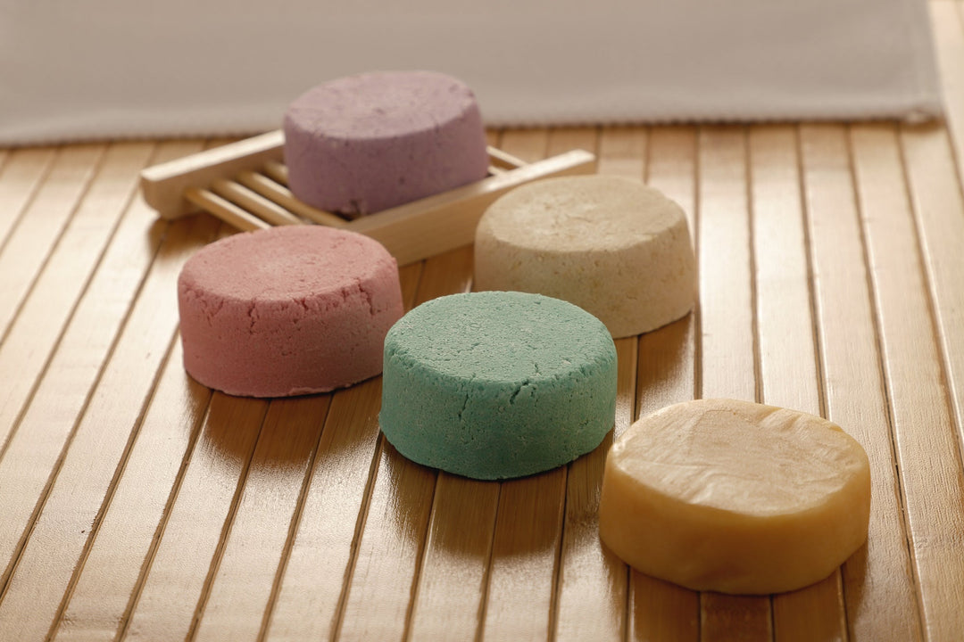All-natural shampoo bar assortment, stacked bars in lavender, pink, green, and cream