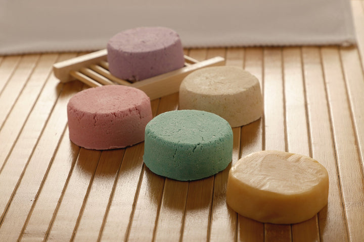 All-natural shampoo bar assortment, stacked bars in lavender, pink, green, and cream