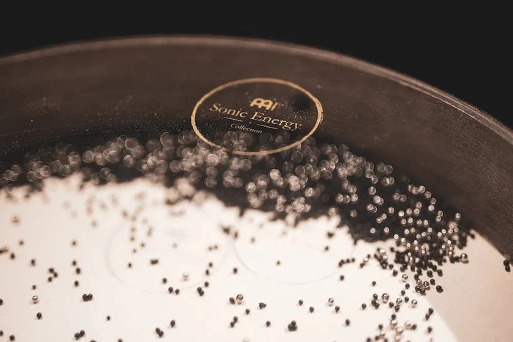 Drumhead with Sonic Energy logo on tan surface, showing dark rim and bead edge
