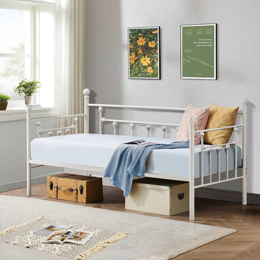 White metal twin daybed frame with paneled headboard, footboard, and slatted base