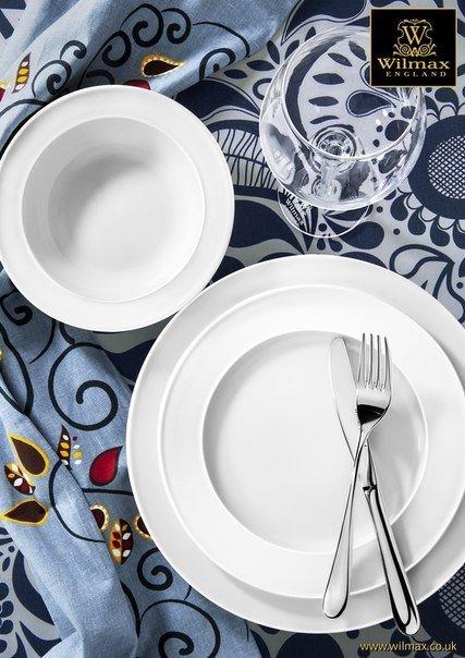 Set of 12 white 7-inch dessert plates, stacked view with fork on one plate.