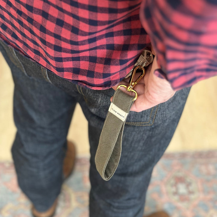 Olive wristlet keychain with gold clasp and fabric strap