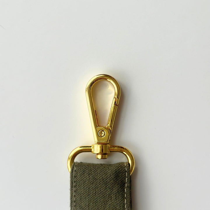 Olive fabric key fob wristlet with gold carabiner-style clasp