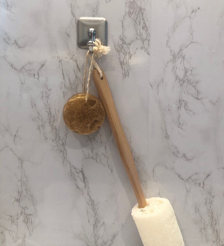Loofah soap on rope with metal hook and wooden scrubber handle.