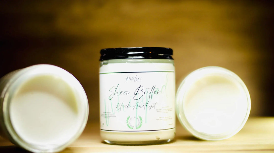 Whipped shea body butter jar with black lid, flanked by two tubs of butter