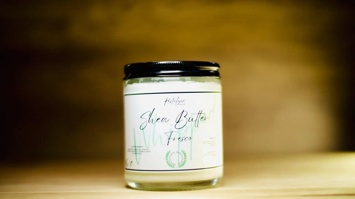 Whipped shea body butter jar with black lid and white label, centered