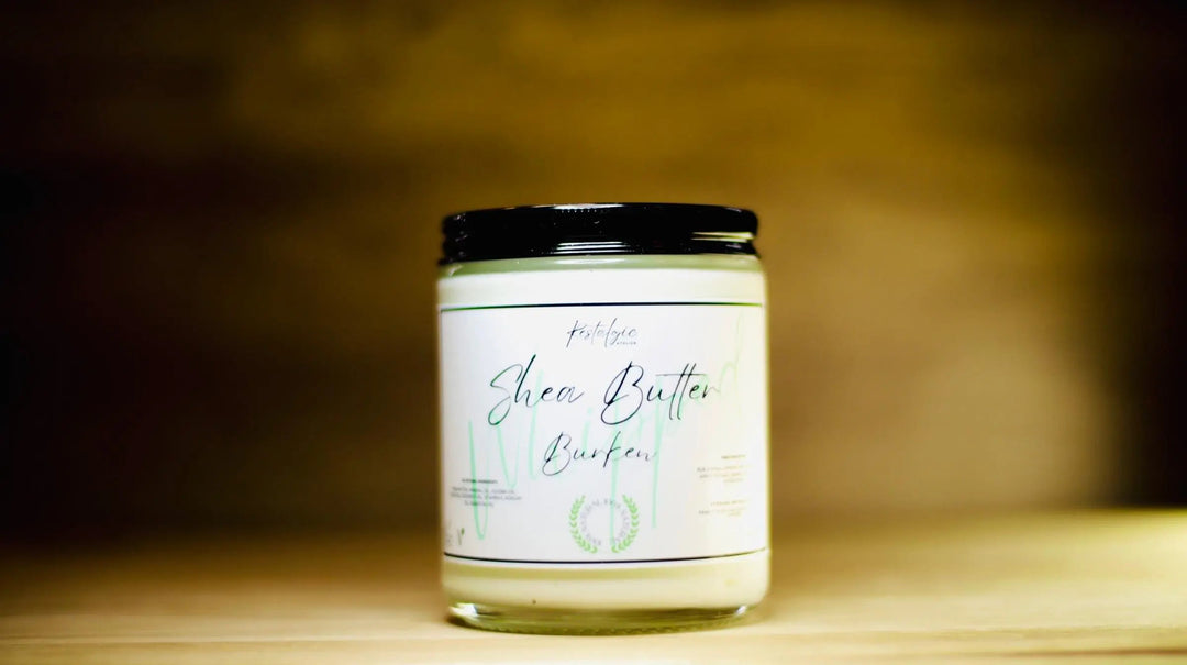 Whipped shea body butter jar with black lid; front view of white label