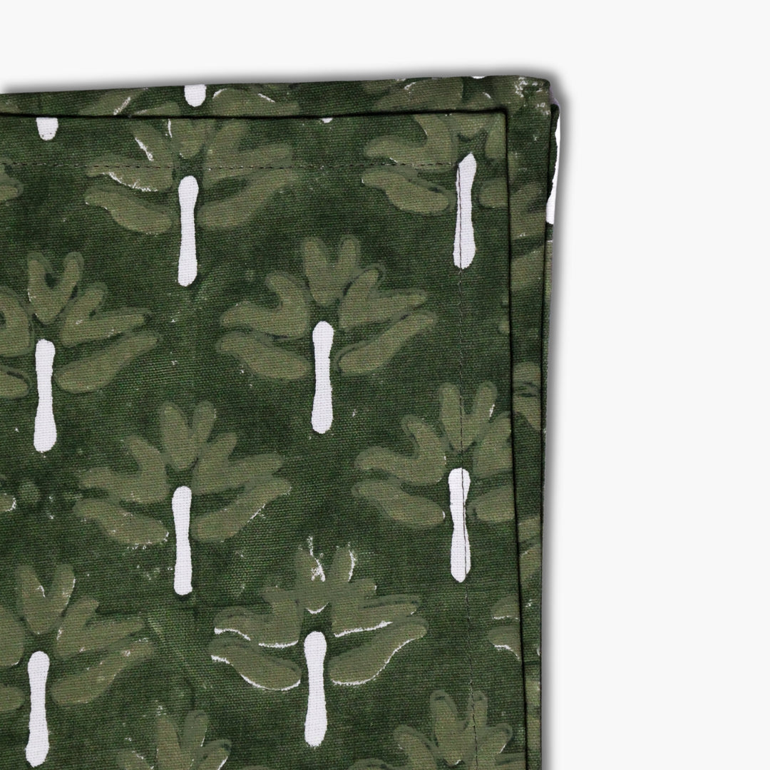 Zeenat table napkin fabric, dark green with white chive-stem motifs, close-up