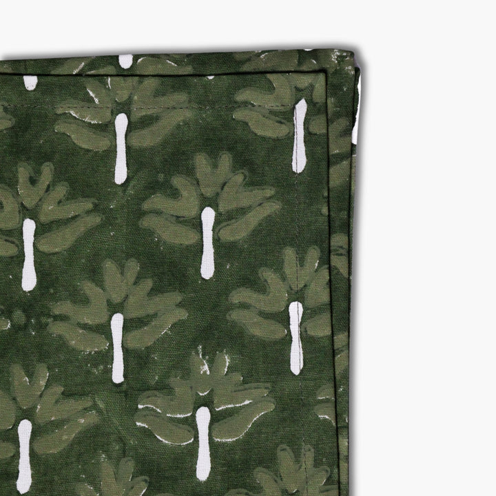 Zeenat table napkin fabric, dark green with white chive-stem motifs, close-up